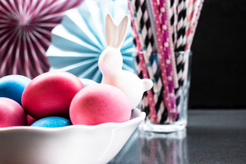 Easter holiday background with eggs, porcelain bunny and paper decoration