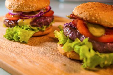 Hommemade fresh tasty hamburgers with cheese and tomato
