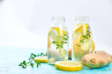 Detox water in bottles with ingredients, ginger, lemon, mint