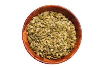 Raw green pumpkin seeds without shells inside wooden bowl. Healthy diet food ingredient in round kitchen container studio background.