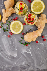 Detox water in bottles with cranberrie, ginger, lemon, mint