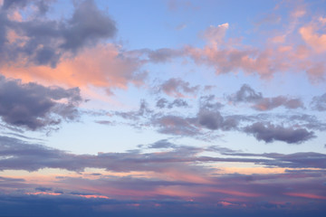 Naklejka na ściany i meble Abstract sky background. Clouds illuminated by the sun at sunset.
