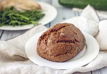 Wholegrain low-calorie bread with flaxseeds from wheat, rye and barley seedlings. Healthy bread for a healthy diet