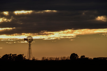 Naklejka premium Landscape with windmill at sunset, Pampas, Patagonia,Argentina