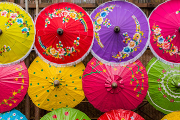 Colorful handmade paper umbrellas on wallpaper at thailand