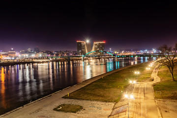 Fototapeta premium Belgrade, Serbia - February 10, 2019: A panorama of Belgrade and Sava river by night. Old Sava bridge and waterfront of Belgrade.