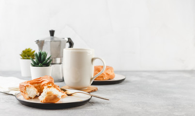 Cream puff rings - choux pastry, and cup of black coffee