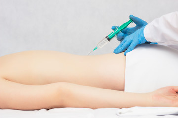 The doctor makes an injection of ozone and chondroprotector in the spine to the patient, ozone...