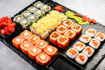 Big sushi set with variety of sushi rolls,on stylish dark background.