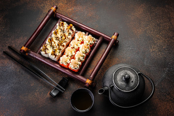 Big sushi set with variety of sushi rolls,on stylish dark background.