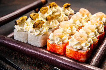 Big sushi set with variety of sushi rolls,on stylish dark background.