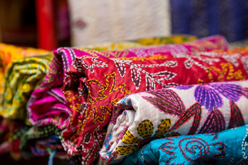 Fototapeta premium Display of colorful traditional batik scarves in the art souvenir shop