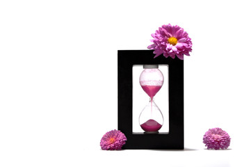 Sand running through the bulbs of an hourglass measuring the passing time in a countdown to a...