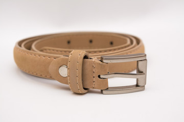 Beige leather belt on a white background.
