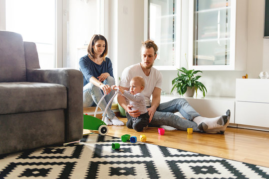 Young parents playing with baby