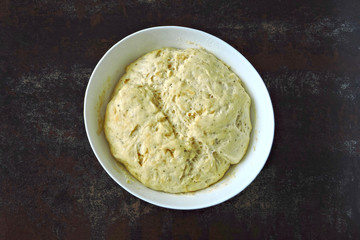 Raw yeast dough in a bowl. Soft and airy yeast dough.