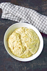 Raw yeast dough in a bowl. Soft and airy yeast dough.