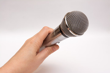 Microphone in hand on white background