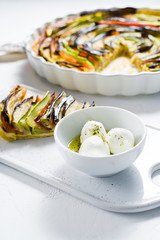 Goat cheese in olive oil and spices. Top view, white background,