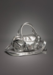 Silver purse/handbag made of leather on gradient gray background