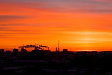 Naklejka premium sunrise in the city with industrial pipes