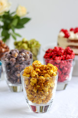 Party table with colorful popcorn in glasses
