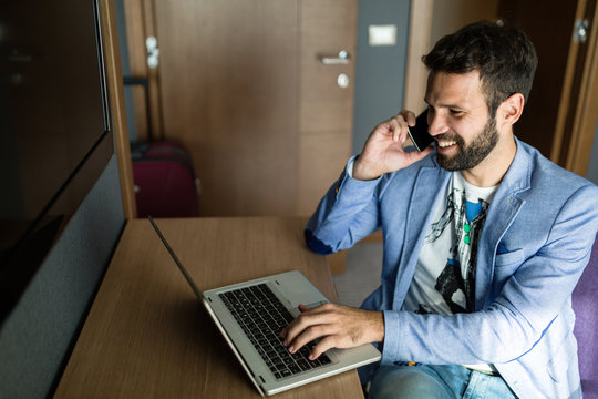 Businessman working on computer in hotel room
