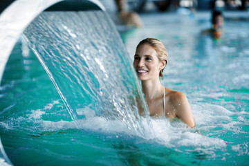 Portrait of beautiful woman relaxing in swimming pool