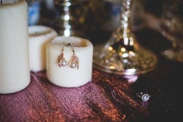 Jewelry earrings on a table with decorative elements