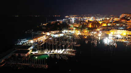 Aerial drone night shot of famous small safe port of Mikrolimano with sailboats docked, Piraeus, Attica, Greece