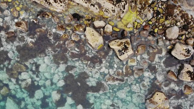 Aerial view. Clear blue sea water with stone rocky fjord shore. Norwegian nature