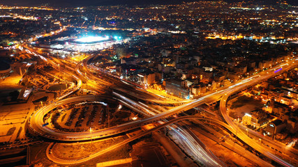 Fototapeta na wymiar Aerial drone night shot of multilevel junction highway with moderate traffic