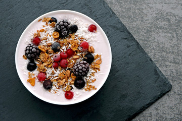 Healthy beautiful breakfast bowl with yogurt, granola and berries.