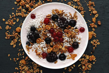 Healthy beautiful breakfast bowl with yogurt, granola and berries.