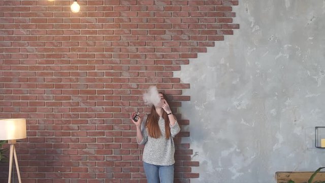 Sexy girl smokes vape.