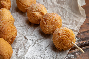 Cottage cheese balls on wooden skewers, lie on craft paper.