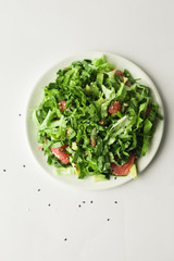 healthy vegan green salad in white bowl