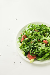 healthy vegan green salad in white bowl
