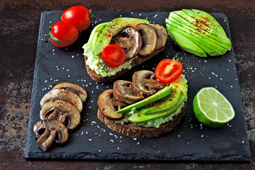 Beautiful healthy avocado toasts with mushrooms.