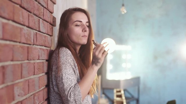 Sexy girl smokes vape.