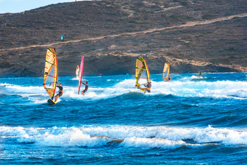Windsurfers and kitesurfers ride on Prasonisi beach (Rhodes, Greece)