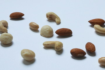 Obraz premium Variety of nuts on white background. Macadamia,cashew,peanuts and almond nuts.