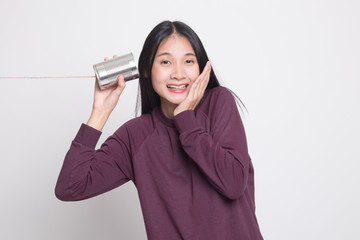 Happy Young Asian woman listen with tin can phone.