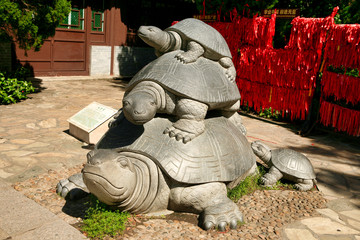  The statue of a tortoise - a symbol of long life in the Valley of Longevity Nanshan Park. Sanya,...