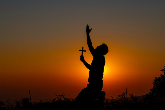 The human hand holds cross a christian religion faith concept