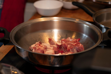 cook preparing lamb soup with vegetables in the kitchen