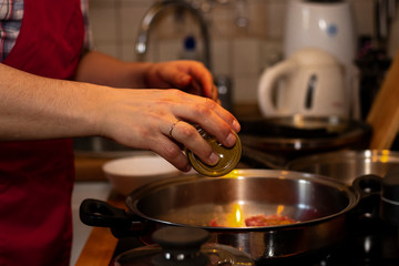 cook preparing lamb soup with vegetables in the kitchen
