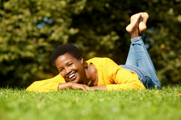 happy young african american woman relaxing in park
