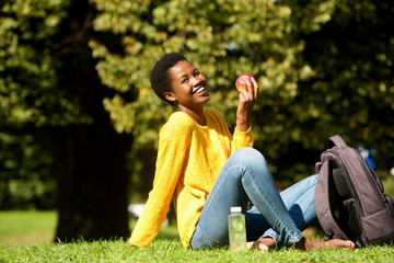 healthy young woman with apple in park