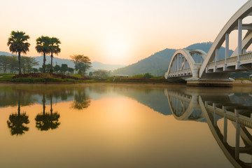 Tha Chom Phu railway bridge or white bridge during morning sunrise, railway bridge in Mae Tha...